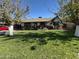 House exterior showcasing a spacious lawn and mature trees at 2649 N Granite Reef Rd, Scottsdale, AZ 85257