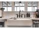 Farmhouse sink with a black gooseneck faucet and white subway tile backsplash at 2649 N Granite Reef Rd, Scottsdale, AZ 85257