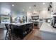 Open concept kitchen with island, white cabinets, and marble countertops at 2649 N Granite Reef Rd, Scottsdale, AZ 85257