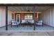 Covered patio with seating area, brick wall, and star patterned tile floor at 2649 N Granite Reef Rd, Scottsdale, AZ 85257