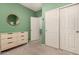 Bright bedroom with double doors leading to closets and dresser at 26538 N 132Nd Ln, Peoria, AZ 85383