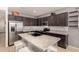 Modern kitchen with dark cabinets and granite countertops at 26538 N 132Nd Ln, Peoria, AZ 85383