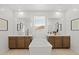 Modern bathroom with double vanity, soaking tub, and ample storage at 27264 N 74Th Ln, Peoria, AZ 85383