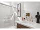 Modern bathroom with a walk-in shower, floating vanity, and gold fixtures at 27264 N 74Th Ln, Peoria, AZ 85383