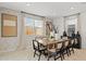 Bright dining room with wood table, cane chairs, and patterned wallpaper at 27264 N 74Th Ln, Peoria, AZ 85383