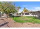 Landscaped backyard with grassy area and mature trees at 2889 E Tremaine Ave, Gilbert, AZ 85234