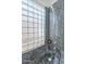 Shower stall with glass block window and blue tile at 2889 E Tremaine Ave, Gilbert, AZ 85234