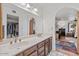 Double sink bathroom vanity with wood cabinets and large mirror at 2889 E Tremaine Ave, Gilbert, AZ 85234