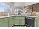 Kitchen with corner sink, light green cabinets, and tile countertops at 2889 E Tremaine Ave, Gilbert, AZ 85234