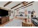 Living room with fireplace, large TV, and wood flooring at 2889 E Tremaine Ave, Gilbert, AZ 85234