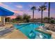 Inviting swimming pool with spa and palm trees at 2889 E Tremaine Ave, Gilbert, AZ 85234