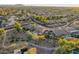 Aerial view of a residential neighborhood with a house featuring a pool and backyard at 2921 S Martingale Rd, Gilbert, AZ 85295