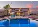 Private backyard with a sparkling pool, patio furniture, and string lights at 2921 S Martingale Rd, Gilbert, AZ 85295