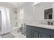 Clean bathroom with white vanity, grey cabinets, and bathtub at 2921 S Martingale Rd, Gilbert, AZ 85295