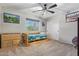 Secondary bedroom with wood floor and ceiling fan at 2921 S Martingale Rd, Gilbert, AZ 85295