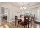 Bright dining room with round table, chandelier, and view into kitchen at 2921 S Martingale Rd, Gilbert, AZ 85295