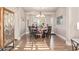 Elegant dining room featuring a round table, chandelier, and hardwood floors at 2921 S Martingale Rd, Gilbert, AZ 85295