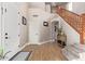 Spacious entryway with hardwood floors, wooden staircase, and neutral color palette at 2921 S Martingale Rd, Gilbert, AZ 85295