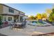 Inviting pool area with patio furniture and a large grassy area at 2921 S Martingale Rd, Gilbert, AZ 85295