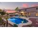 Enjoy evenings by the pool with string lights and a relaxing patio at 2921 S Martingale Rd, Gilbert, AZ 85295