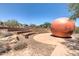 Landscaped amphitheater with a large sphere art piece at 30034 N 128Th Ave, Peoria, AZ 85383