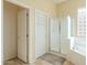 Bathroom with shower, linen closet, and tile flooring at 30034 N 128Th Ave, Peoria, AZ 85383