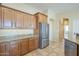 Well-equipped kitchen featuring wood cabinets and granite countertops at 30034 N 128Th Ave, Peoria, AZ 85383