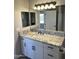 Bathroom with granite countertop, white cabinets, and a walk-in shower at 34902 W Caldwell St, Tonopah, AZ 85354