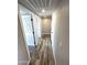 Hallway with wood-look floors and access to bedrooms at 34902 W Caldwell St, Tonopah, AZ 85354