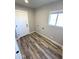 Laundry room with wood-look flooring and white door at 34902 W Caldwell St, Tonopah, AZ 85354