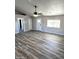 Bright and airy living room with wood-look floors and ceiling fan at 34902 W Caldwell St, Tonopah, AZ 85354