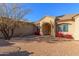 Brick paved courtyard with red flowering bushes and a view of the home's entrance at 3630 W Bohl St, Laveen, AZ 85339