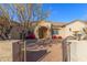 Front entry of the house with a paved walkway and wrought iron gate at 3630 W Bohl St, Laveen, AZ 85339