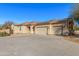 House exterior showcasing a 3-car garage and solar panels on the roof at 3630 W Bohl St, Laveen, AZ 85339