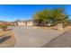 Long driveway leading to a single-story home with a 2-car garage and desert landscaping at 3630 W Bohl St, Laveen, AZ 85339