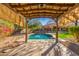 Inviting pool with a pergola and lush landscaping at 3630 W Bohl St, Laveen, AZ 85339