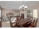 Bright dining room with a large wooden table and chandelier at 3817 E Cielo Grande Ave, Phoenix, AZ 85050