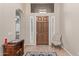 Bright entryway with tile flooring, chair, and wooden console table at 3817 E Cielo Grande Ave, Phoenix, AZ 85050