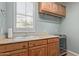 Laundry room with wood cabinets and built-in beverage fridge at 3817 E Cielo Grande Ave, Phoenix, AZ 85050