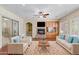 Living room with hardwood floors, stone fireplace, and built-in shelving at 3817 E Cielo Grande Ave, Phoenix, AZ 85050