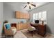 Bright home office features built-in cabinetry and wood desk at 3817 E Cielo Grande Ave, Phoenix, AZ 85050