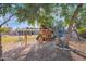 Wooden playset nestled under large trees in backyard at 3848 W Morrow Dr, Glendale, AZ 85308