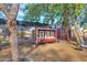 Rustic red chicken coop in backyard with shade cover at 3848 W Morrow Dr, Glendale, AZ 85308