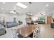 Open concept dining area with a wooden table and living room view at 3848 W Morrow Dr, Glendale, AZ 85308