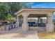 Outdoor kitchen and seating area under covered pavilion at 3848 W Morrow Dr, Glendale, AZ 85308