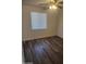 Second bedroom with wood-look flooring and window blinds at 3941 E Emile Zola Ave, Phoenix, AZ 85032