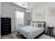 Inviting bedroom with stylish decor, featuring a window with blinds, bed, and side tables at 4058 E Erie E St # 103, Gilbert, AZ 85295