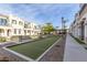 Bocce ball court in a community with landscaped greenery, benches and sidewalks between the townhomes at 4058 E Erie E St # 103, Gilbert, AZ 85295