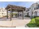 Community picnic area featuring a grill and seating under a shade structure, with townhomes nearby at 4058 E Erie E St # 103, Gilbert, AZ 85295