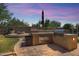 Outdoor kitchen, fire pit, and sparkling pool create a relaxing backyard oasis at 4113 E Burnside Trl, Cave Creek, AZ 85331